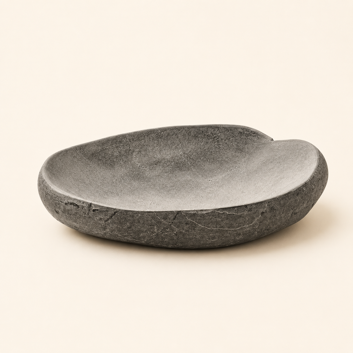 Dark gray stone bowl on a beige background