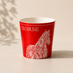 Red cup with white horse design and HORSE text on a beige background