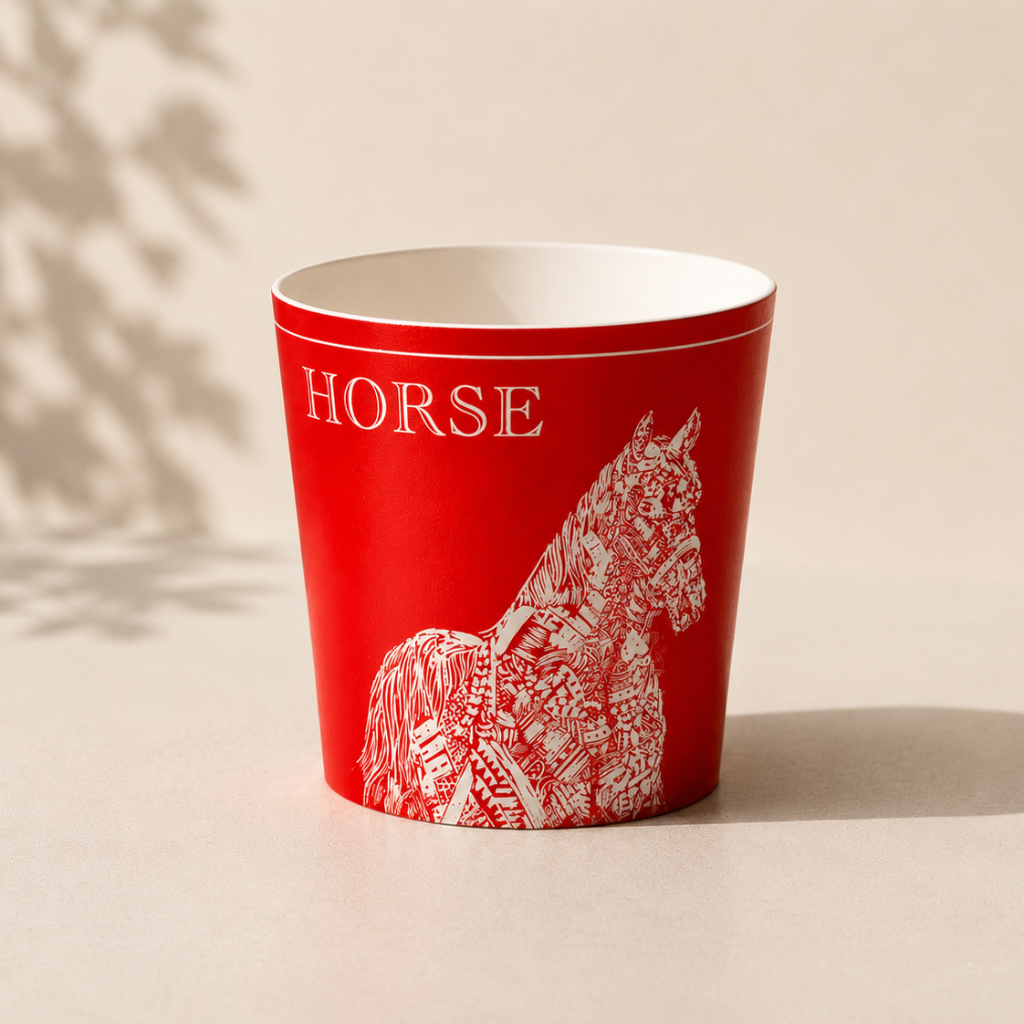 Red cup with white horse design and HORSE text on a beige background