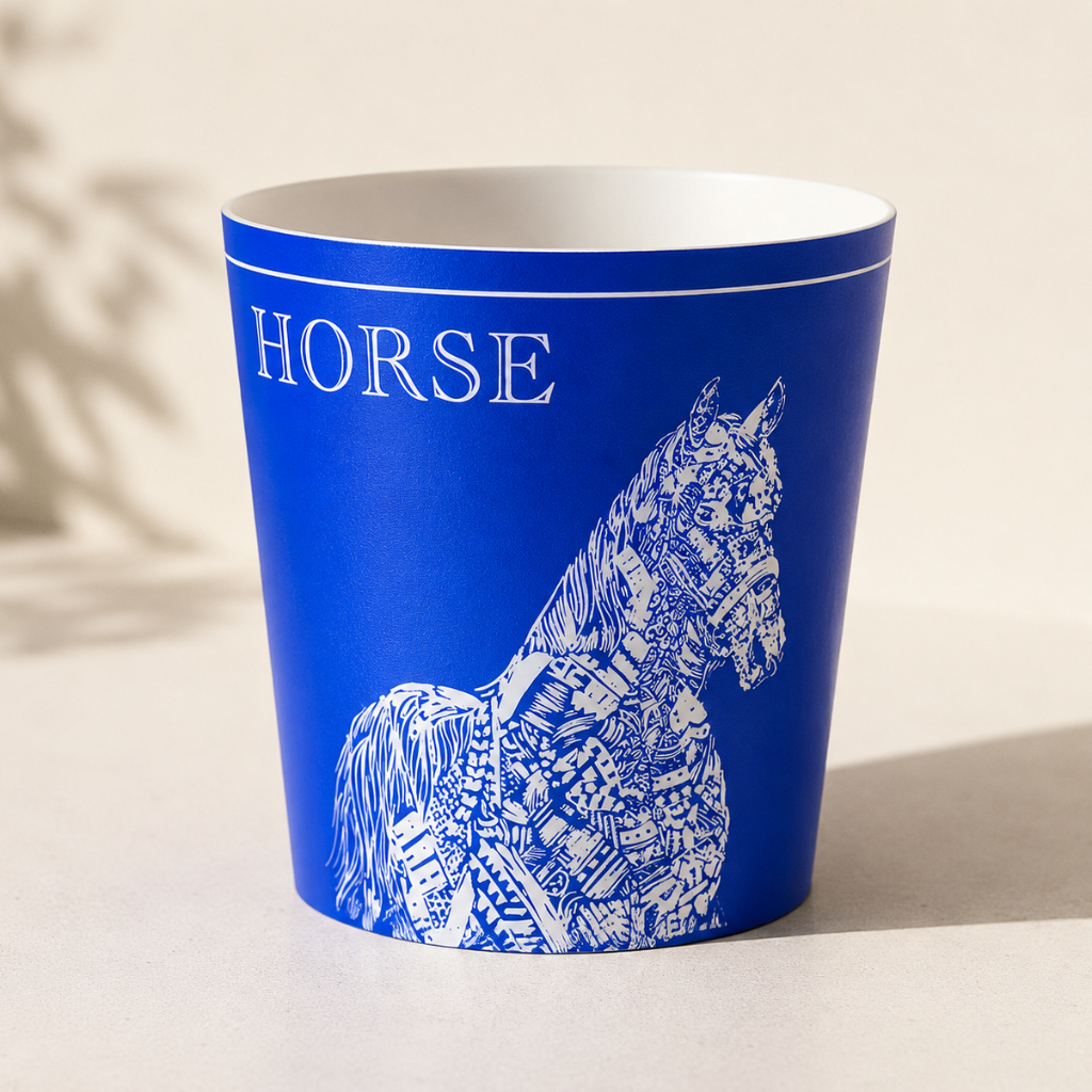 Blue cup with white horse design and HORSE text on a beige background