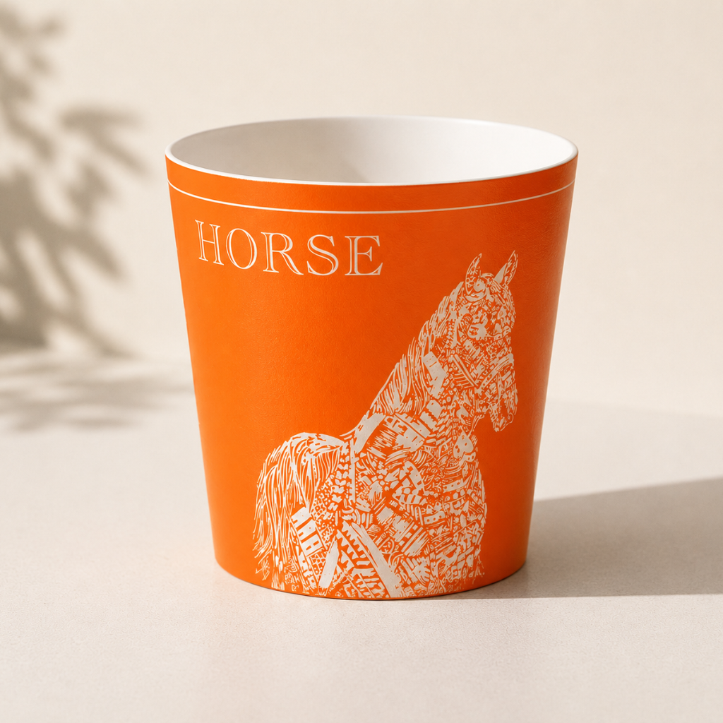 Orange cup with white horse design and HORSE text on a beige background