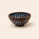 Ceramic bowl with blue interior on a beige background