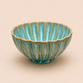 Decorative ceramic bowl with ribbed texture on a beige background