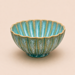 Decorative ceramic bowl with ribbed texture on a beige background