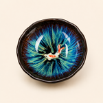Ceramic bowl with a fish design on a beige background