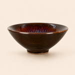Brown ceramic bowl on a beige background