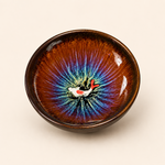 Ceramic bowl with a fish design on a beige background