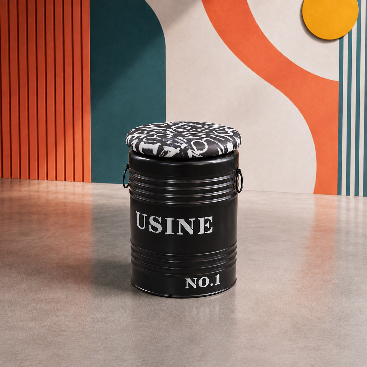 A black metal storage bin with a cushioned black-and-white patterned lid, featuring the text USINE NO.1 on the front, set against a modern geometric wall background. 