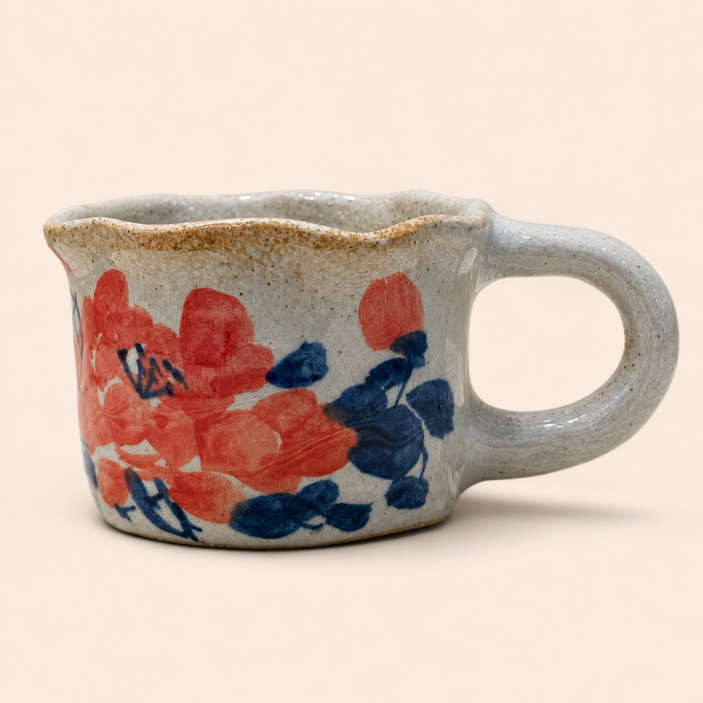 Ceramic pitcher with floral design on a beige background