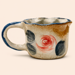 Ceramic mug with floral design on a beige background