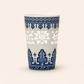White ceramic cup with blue decorative patterns on a white background