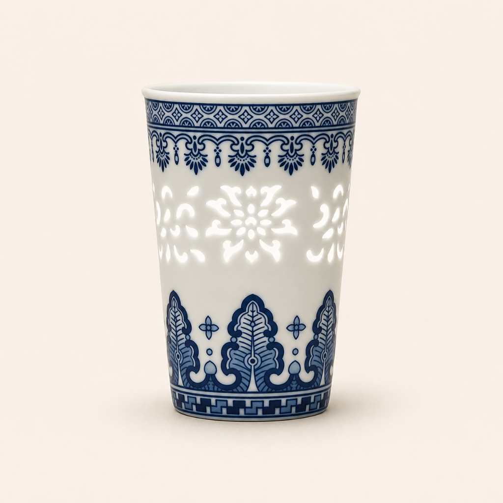 White ceramic cup with blue decorative patterns on a white background