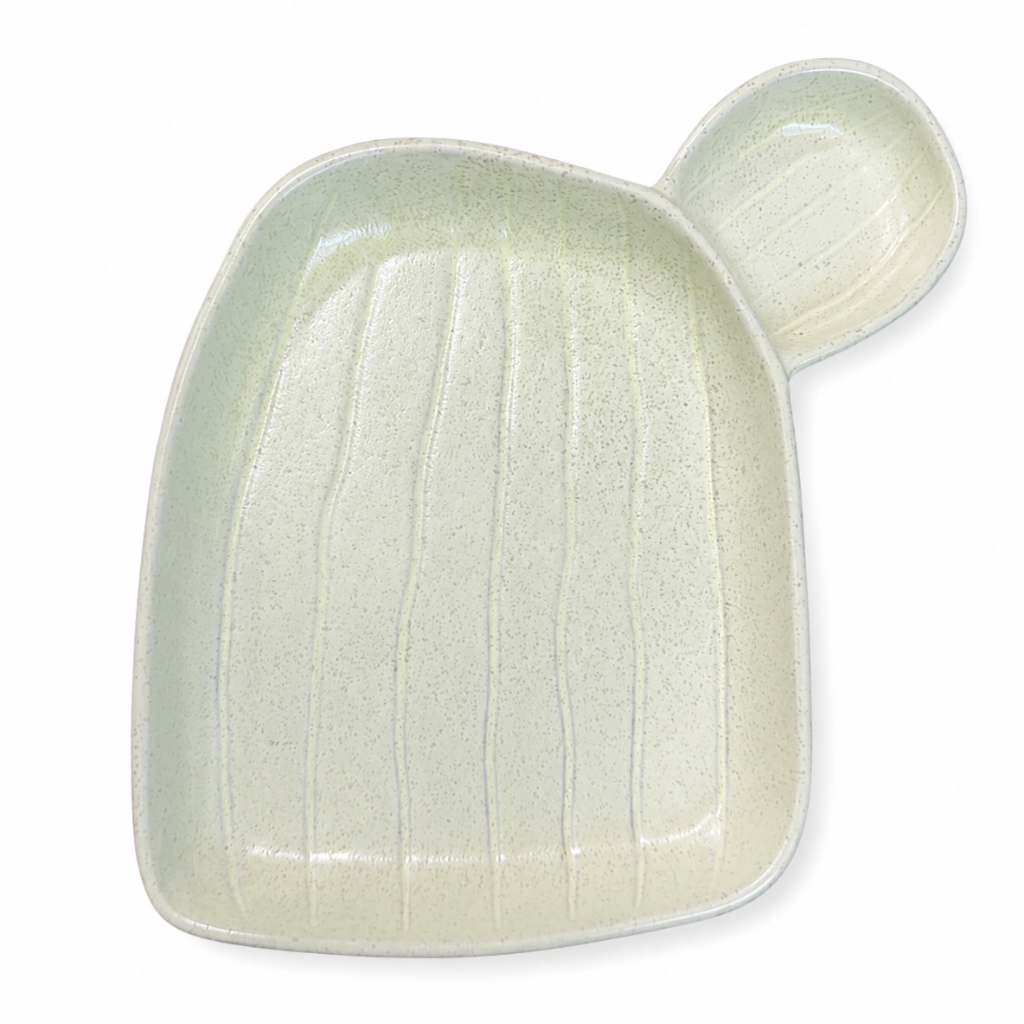 White ceramic plate with a textured surface on a white background