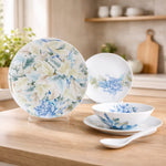 Ceramic dinnerware set with floral design on a wooden surface