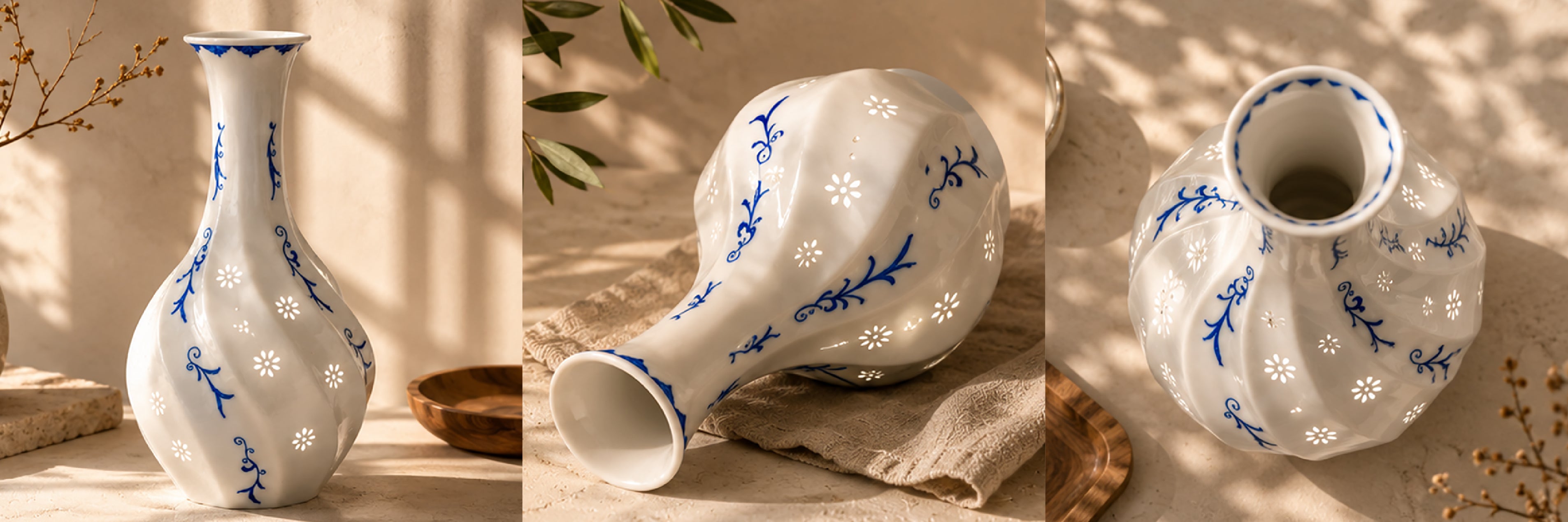 Three white vases with blue floral patterns on a neutral background